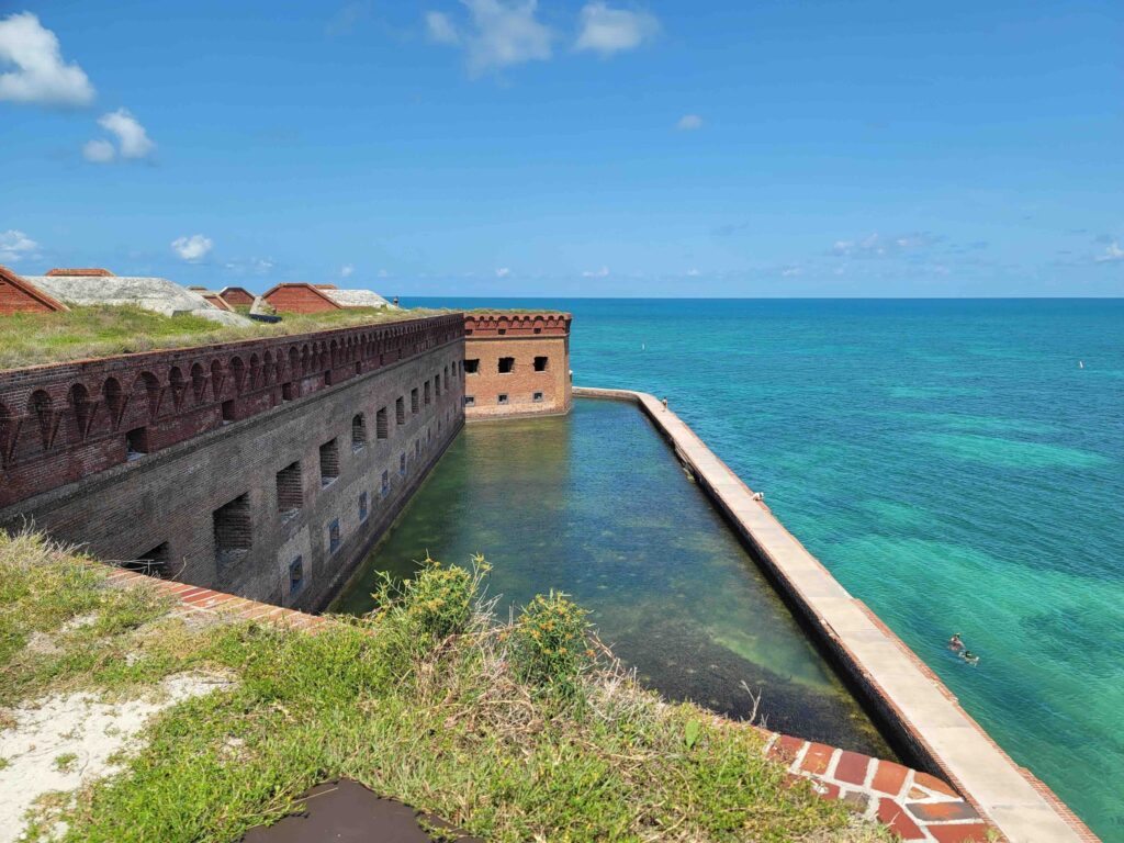 A high-angle view looking down at the massive brick walls and inner moat of Fort Jefferson.