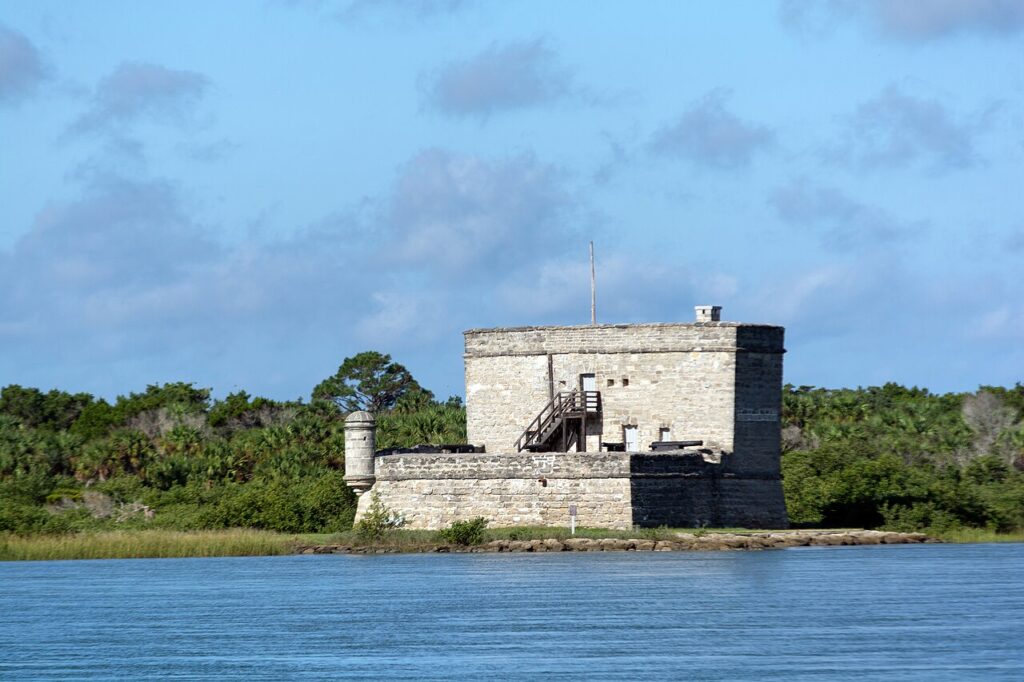 The historic stone structure of Fort Matanzas sitting on a coastal waterway.