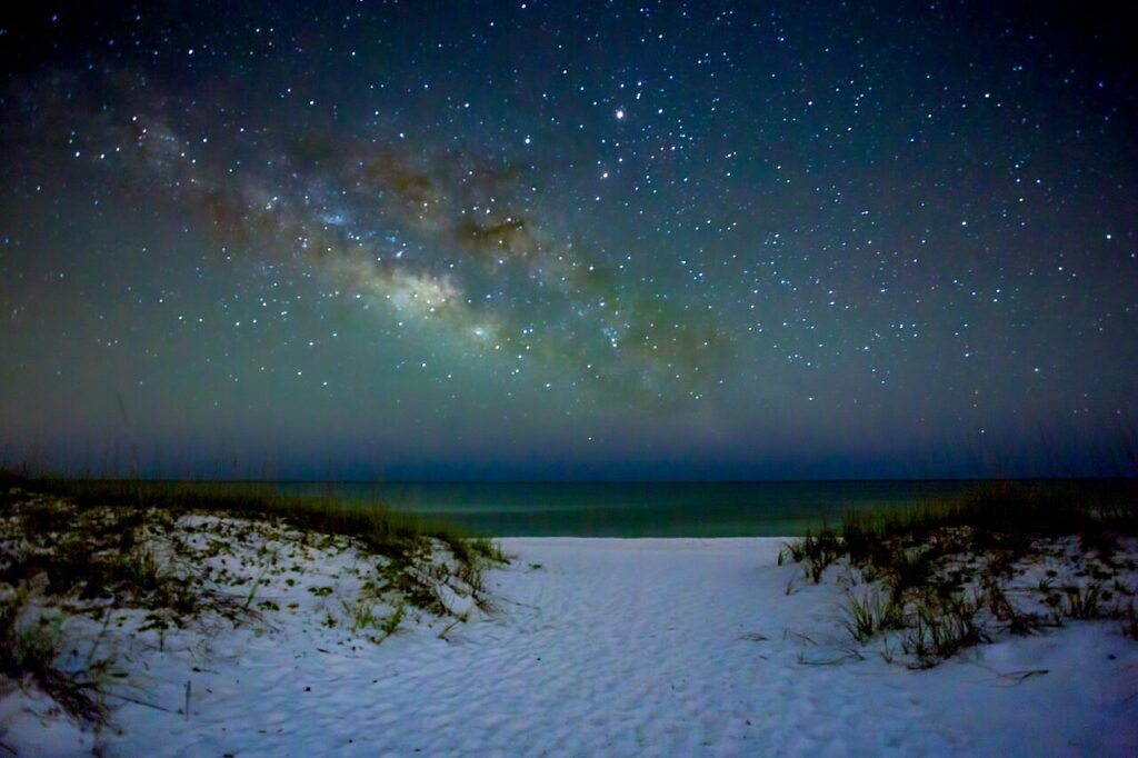 A stunning night view of the Milky Way over the white sand dunes at Gulf Islands National Seashore.