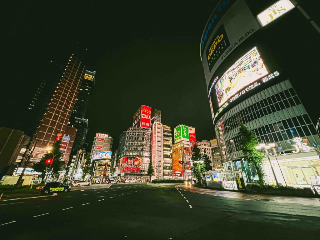 Neon-lit Tokyo street at night, a vibrant city to explore during the cheapest time to fly to Japan.