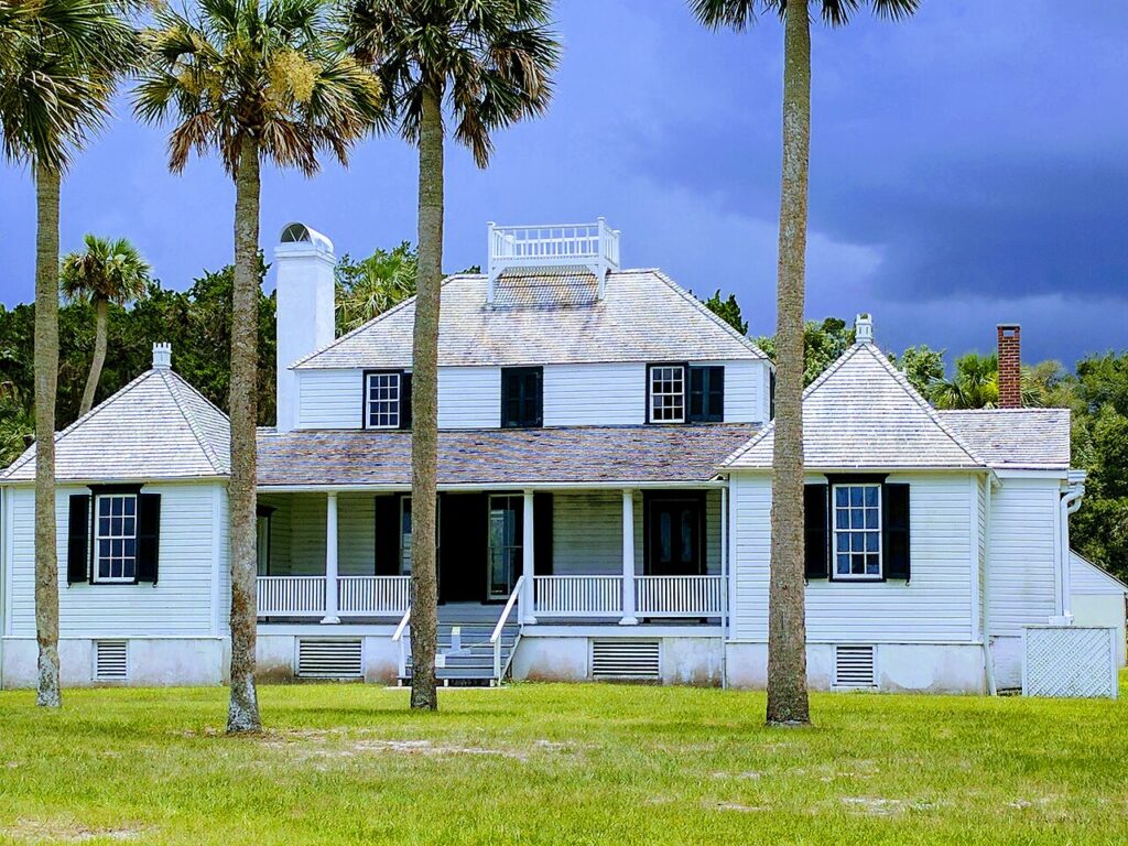 The historic white wooden Main House at Kingsley Plantation with a wide porch.