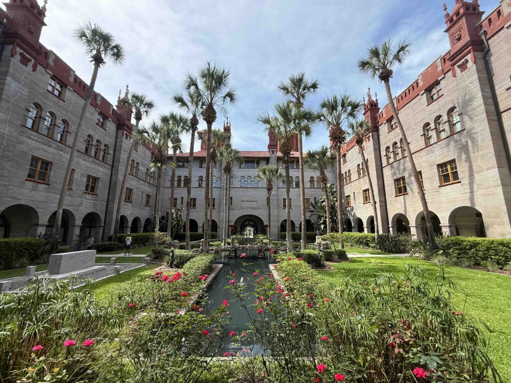 A lush courtyard with a water channel at the former Hotel Alcazar.