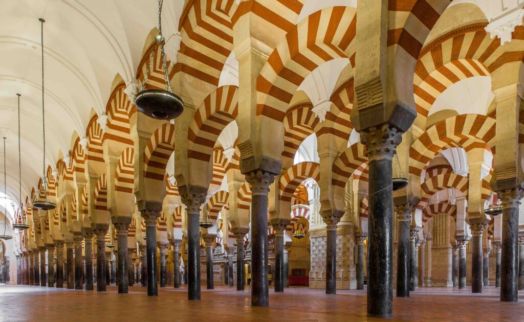 Red and white striped arches inside the historic Mezquita of Cordoba.
