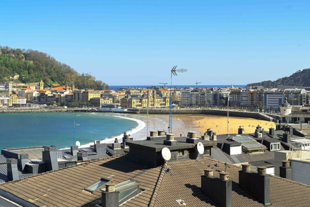 A crescent-shaped beach and green hills in San Sebastian, Northern Spain.