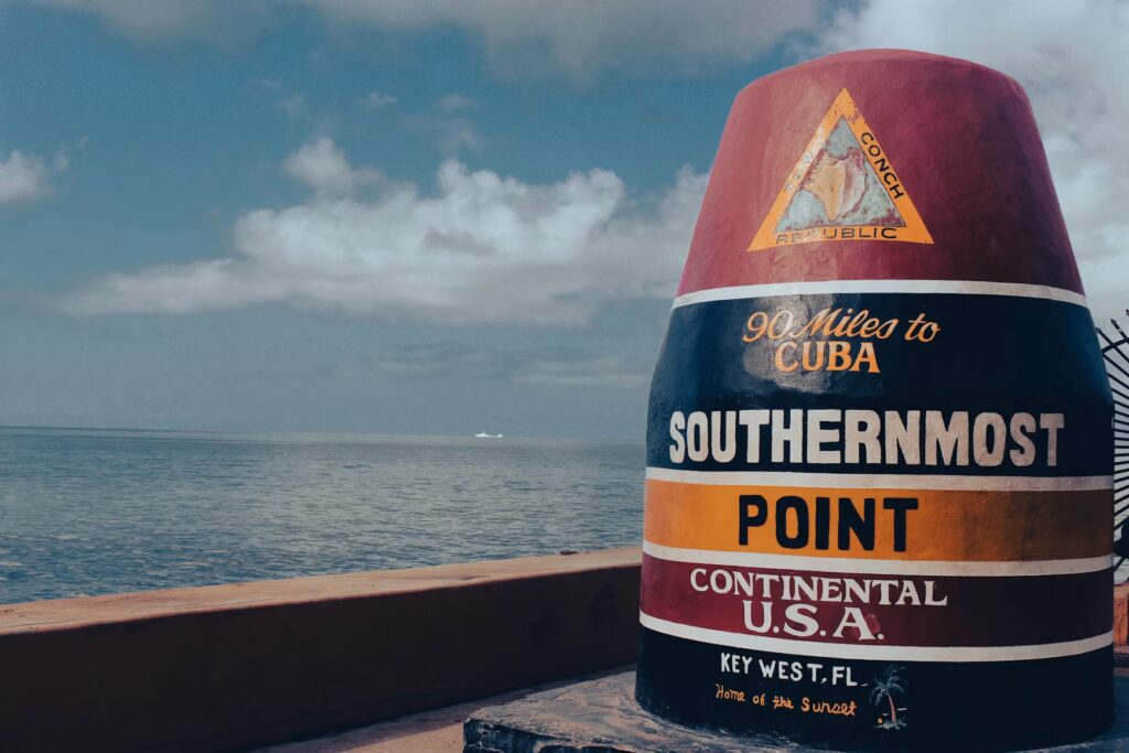 The iconic candy-striped Southernmost Point buoy marking 90 miles to Cuba in Key West.