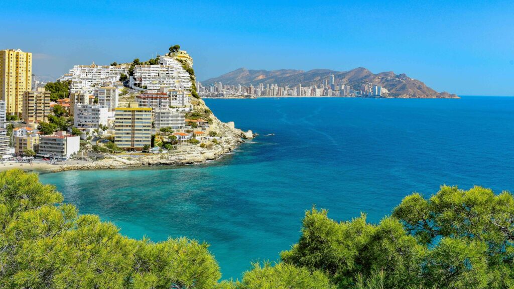 Best Time to Visit Spain in 2026 (And the 3 Months to Avoid for Heat & Crowds) Sunny Mediterranean coastal city view showing the best time to visit Spain.