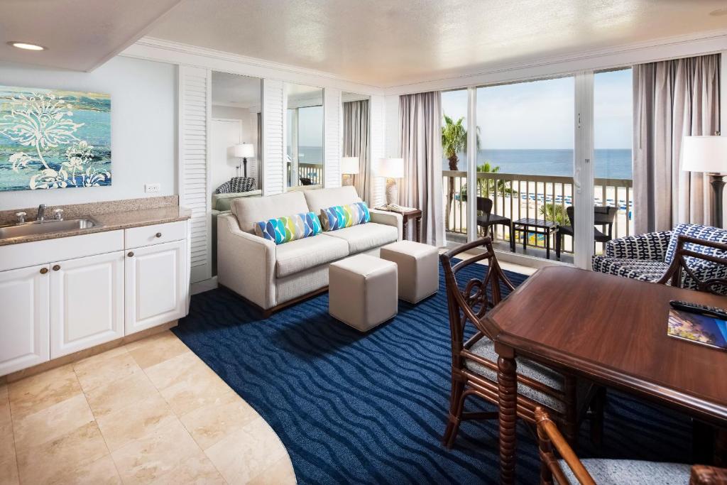 Coastal suite living room with ocean balcony at florida beach resort bundles.