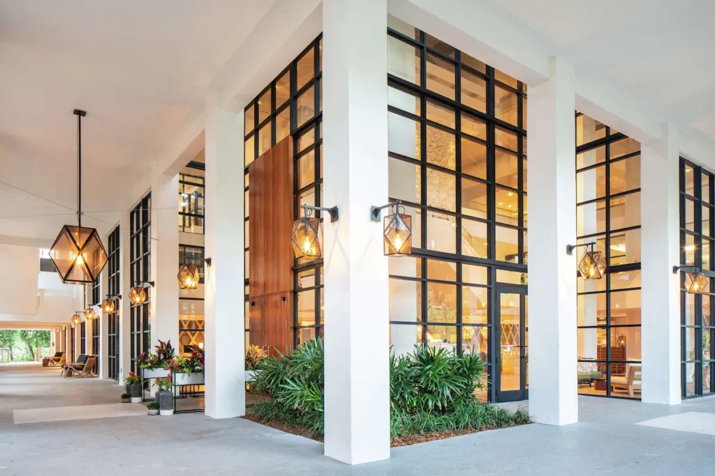 Glass window resort entrance for curated florida culinary vacation bundles.