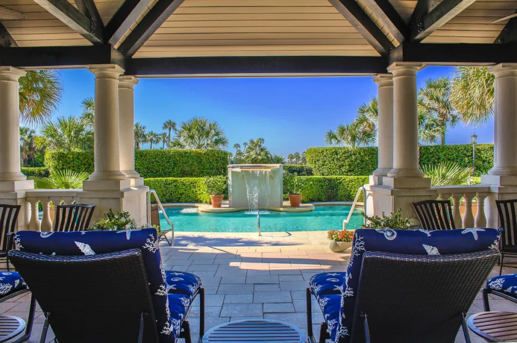 Intimate pool courtyard with archways at boutique oceanfront spot.