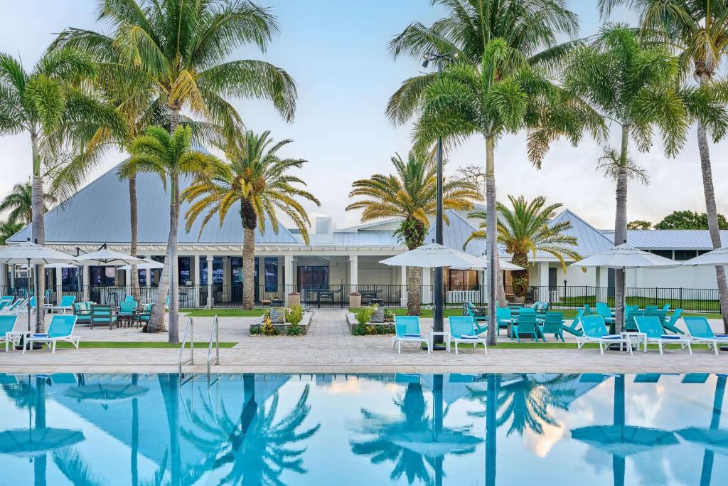 Large resort swimming pool surrounded by palms at an all inclusive resort in FL.