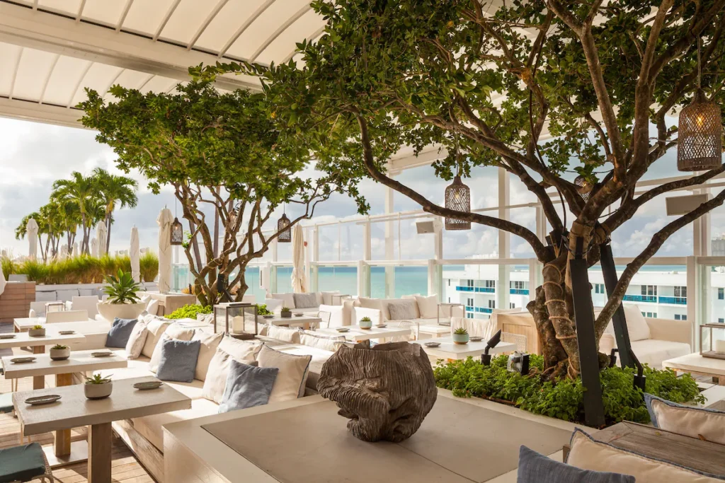 Lush rooftop restaurant with ocean views at Florida beachfront resorts.