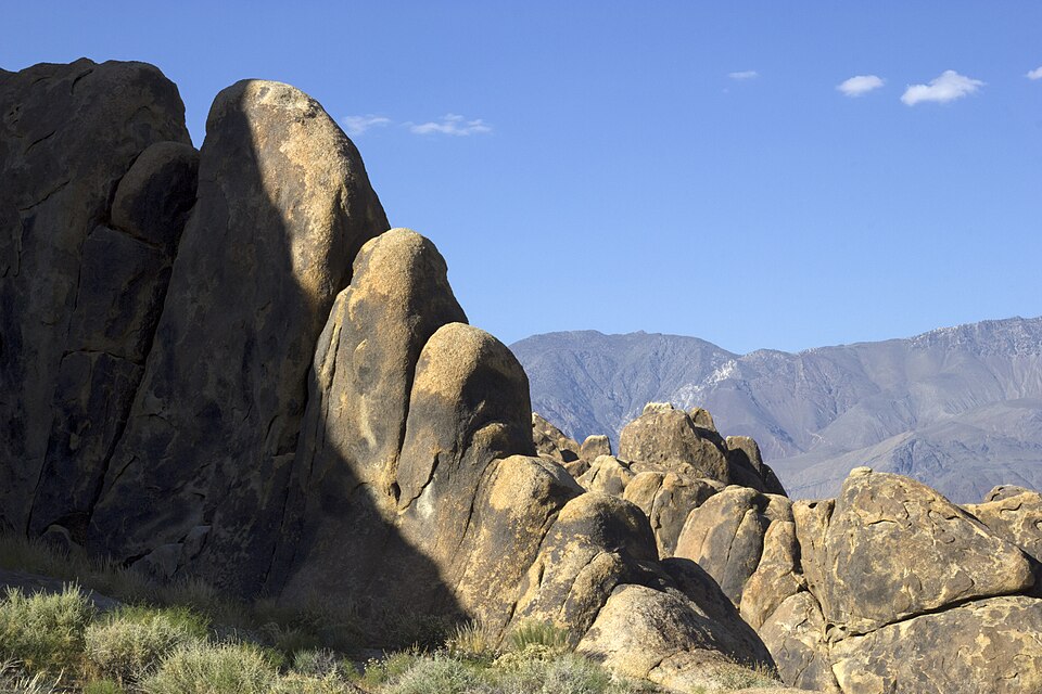 Natural granite rock arch and mountains for free dispersed camping in CA.
