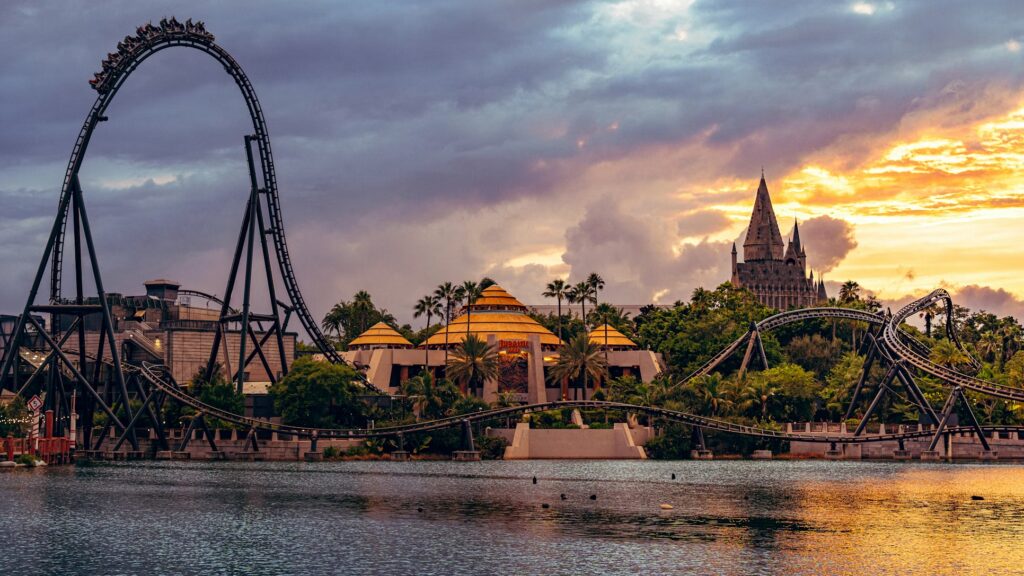 Roller coasters at Universal Orlando Resort during a golden sunset, a highlight for those planning a Florida trip.