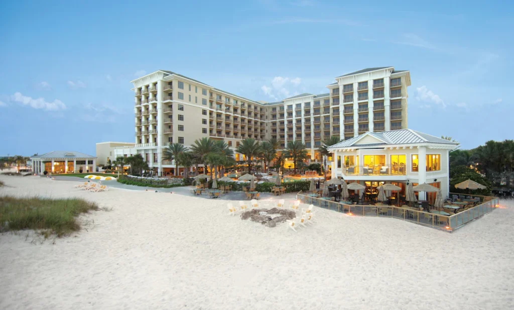 Resort exterior along white sand beach at FL vacation spots.