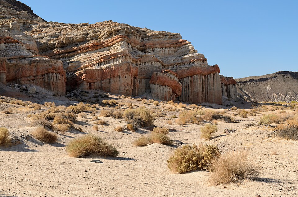 Sculpted red and orange sandstone rock hoodoos at california desert campgrounds.