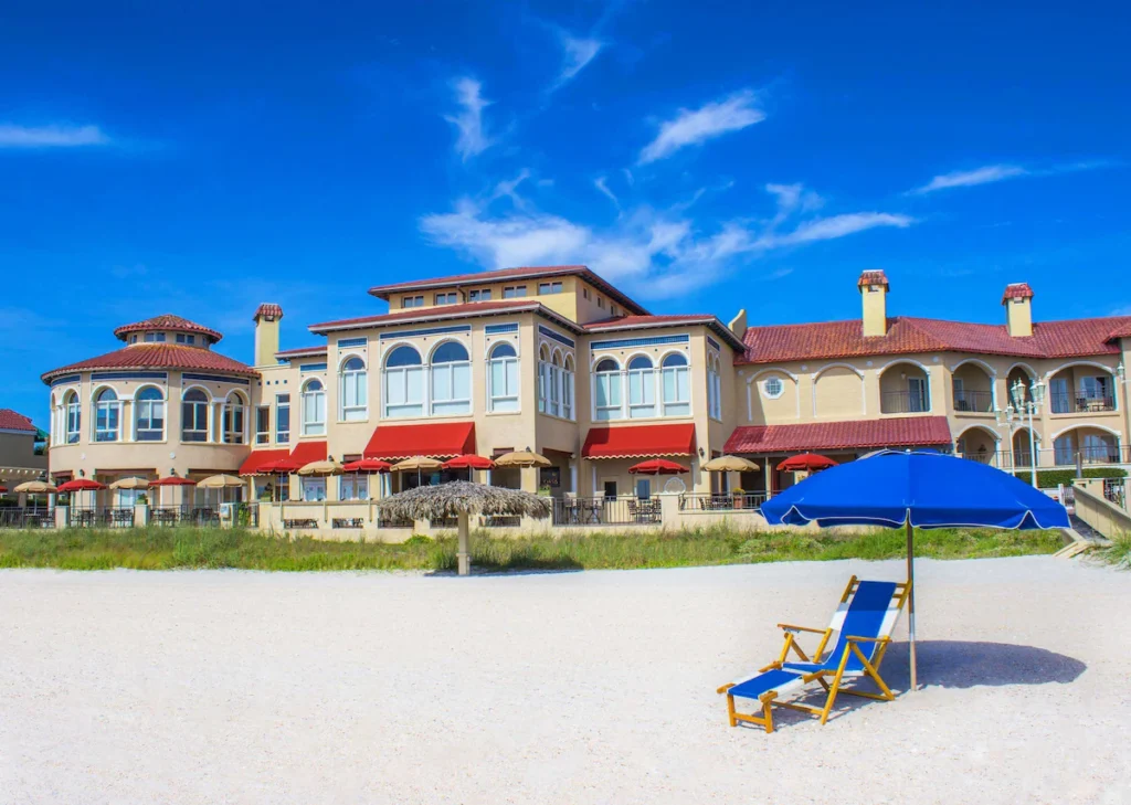 Spanish colonial resort exterior on white sand beach at Florida retreats.