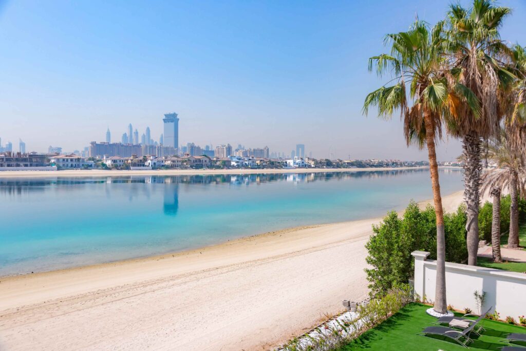 Peaceful sandy beach facing city skyline for perfect Dubai vacation timing.