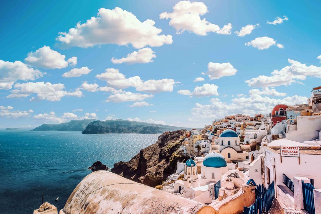 Where to Go in Greece: 12 Best Places for First-Timers Whitewashed buildings and blue domes illustrate best places to visit in Greece for first-timers.