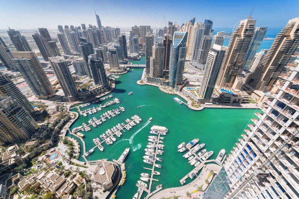 Best Time to Visit Dubai (2026): Layovers, Winter Escapes & Months to Avoid Aerial view of cityscape and marina representing the best time to visit Dubai.