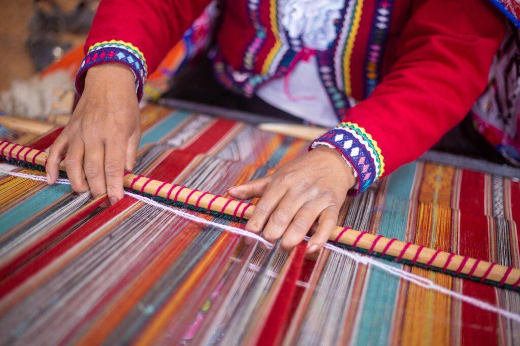 Quechua weaver crafting traditional Andean textile, among Peru's famous things.