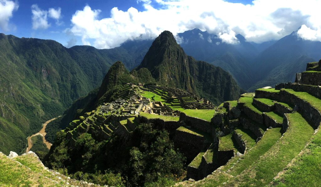 Best Time to Visit Machu Picchu (2026): Weather, Crowds & Ticket Guide Panoramic view of ancient stone terraces during the best time to visit Machu Picchu.