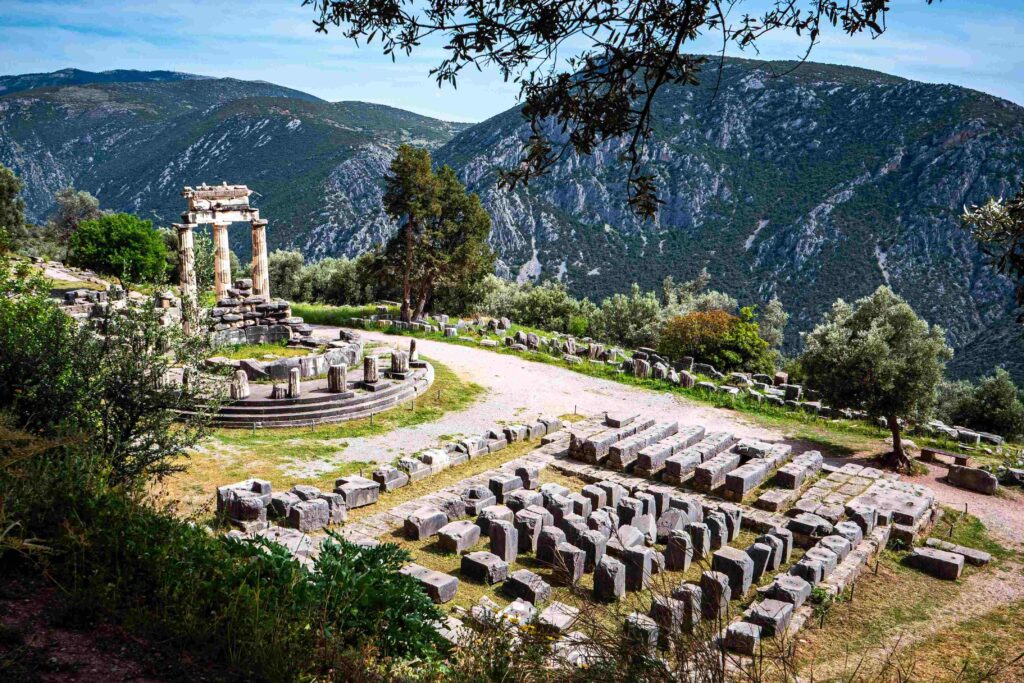 Archaeological ruins of Delphi surrounded by mountains highlighting must-see Greece destinations.