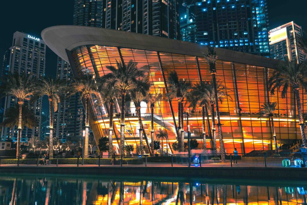 Illuminated dhow shaped building of Dubai Opera at night, top choice among Dubai tourist attractions.