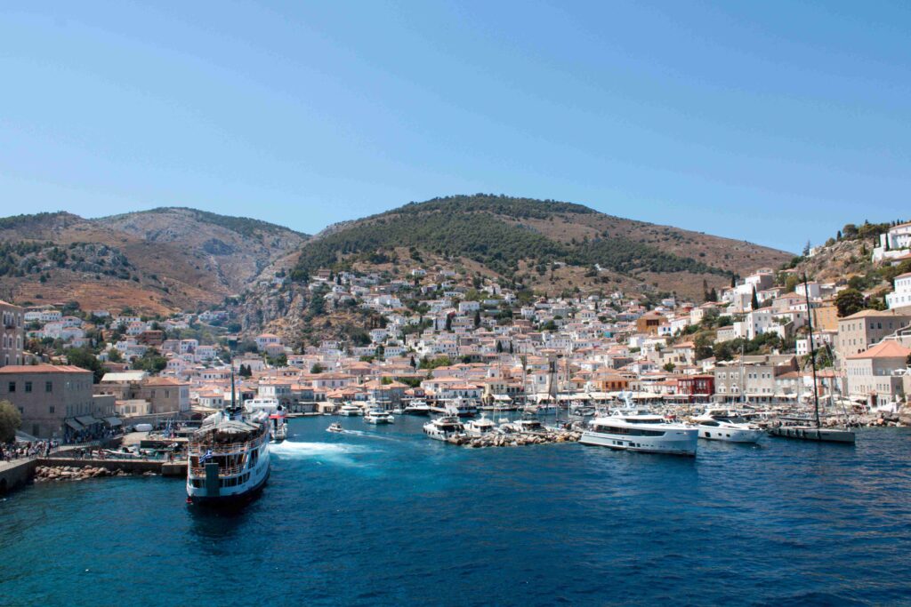 Picturesque Hydra harbor filled with boats, making it one of the best Greece island getaways.