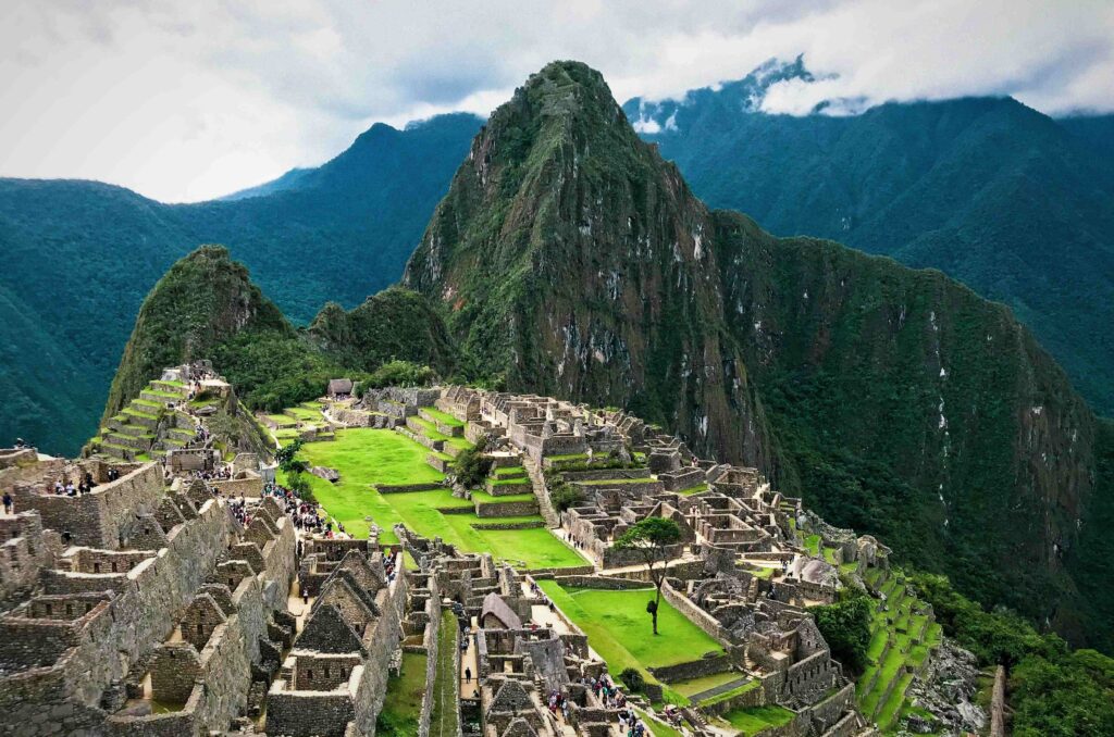Best Time to Visit Peru (2026): Coast, Andes & Amazon Weather Ancient ruins of Machu Picchu nestled in green mountains showcasing best time to visit Peru.