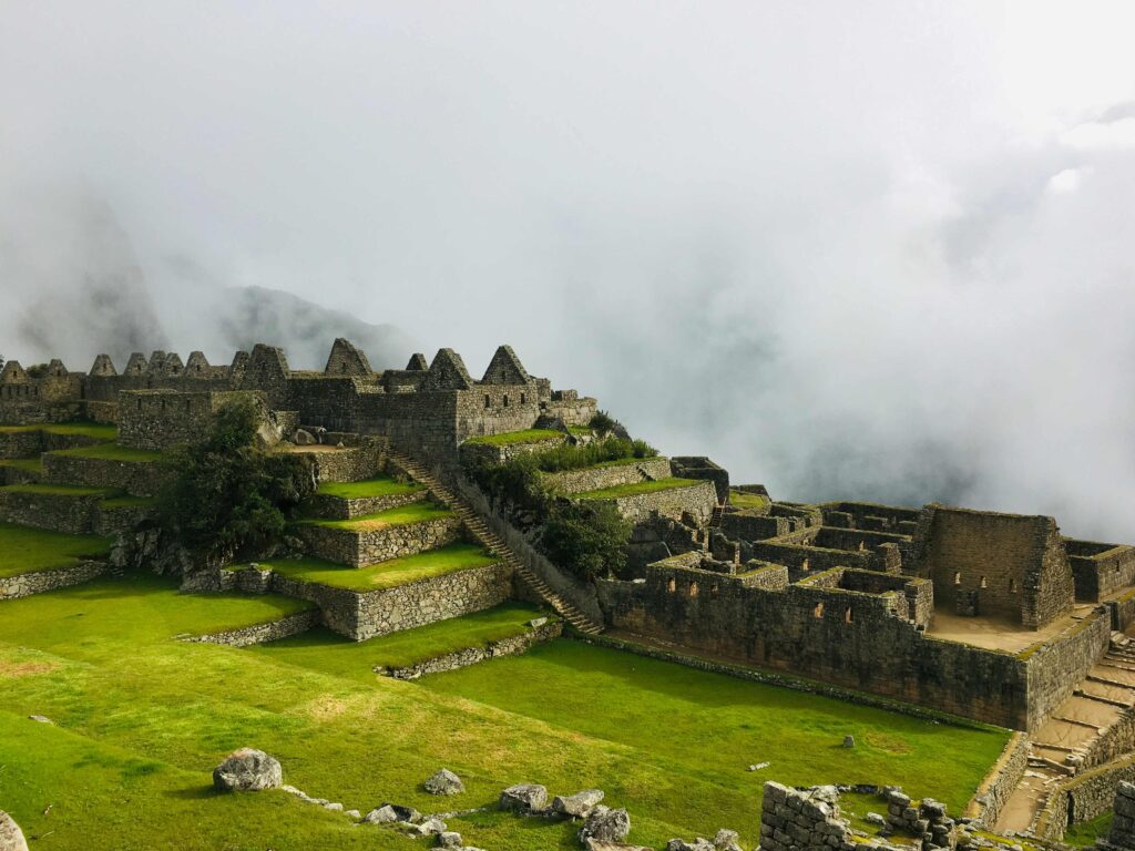 Misty clouds veiling stone ruins, showing microclimates for when to visit machu picchu.