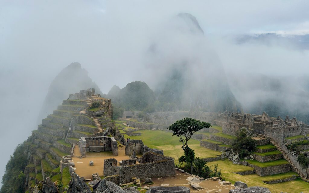 Thick morning fog over stone terraces, ideal for Machu Picchu, the best time of year.