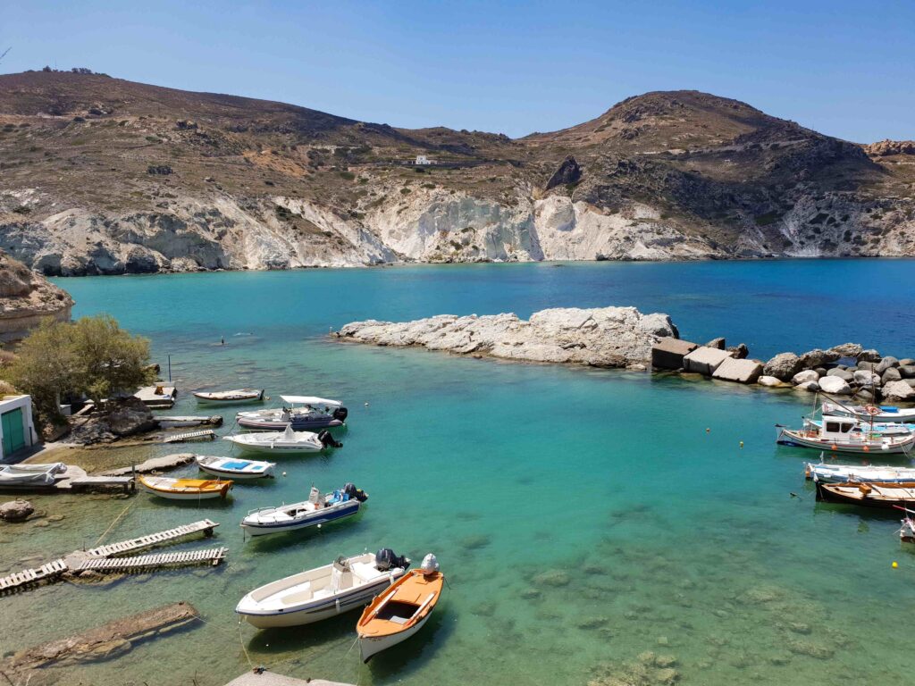 Clear blue water and fishing boats in Milos, ranked among the top islands in Greece.