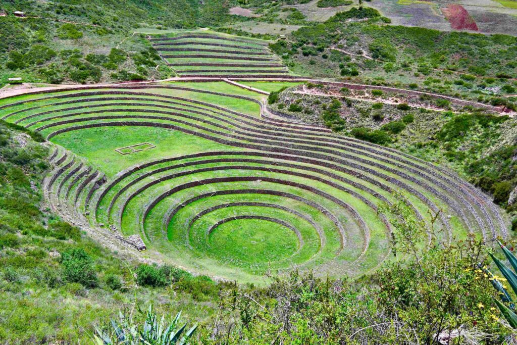 Massive circular terraced bowls engineered by Incas at Moray, top tourist attractions in Peru.