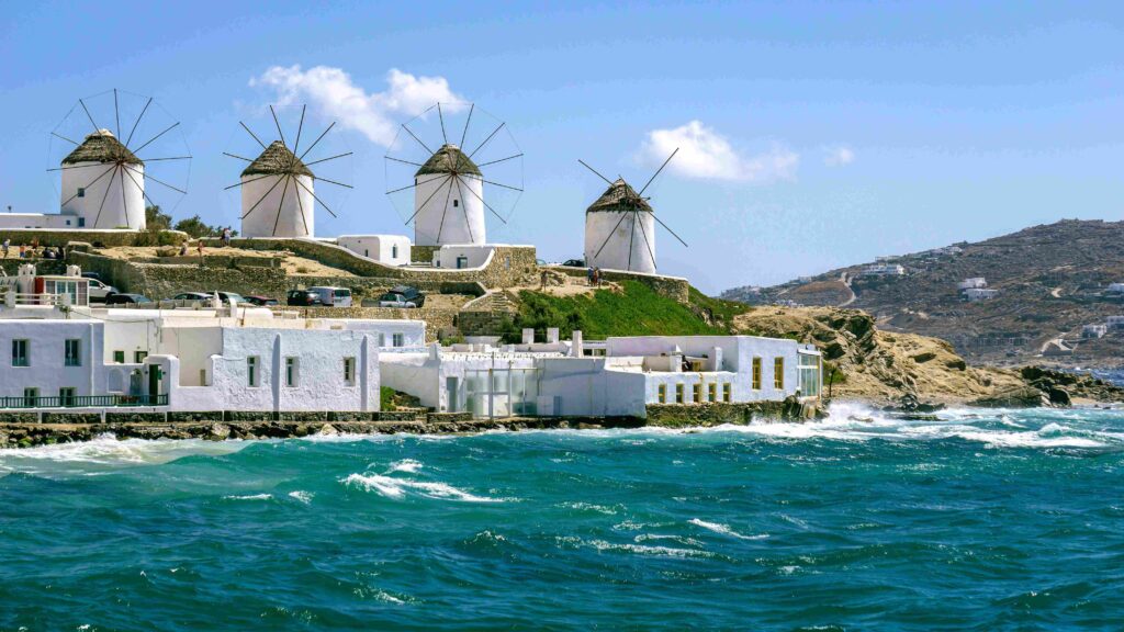 Waterfront view of Mykonos town harbor showcasing famous Greece islands for luxury travelers.