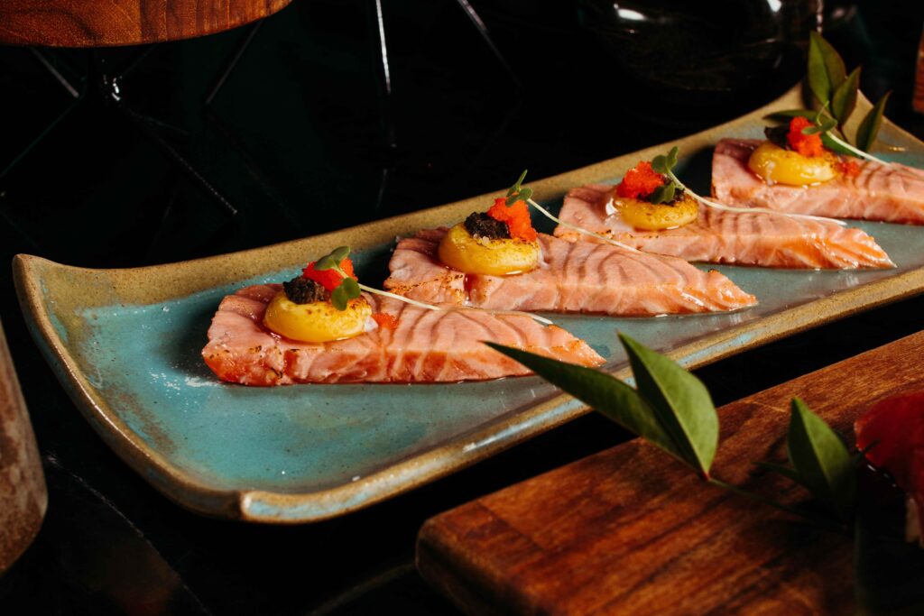 Gourmet Nikkei salmon tiradito plate representing modern Peru food culture.