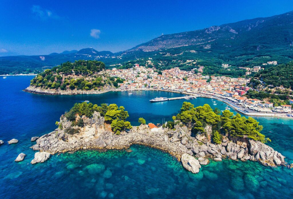 How Many Islands Does Greece Have? 227 Inhabited, 12 You Must See Aerial view of a coastal town showing sea geography and how many Greek islands are there.
