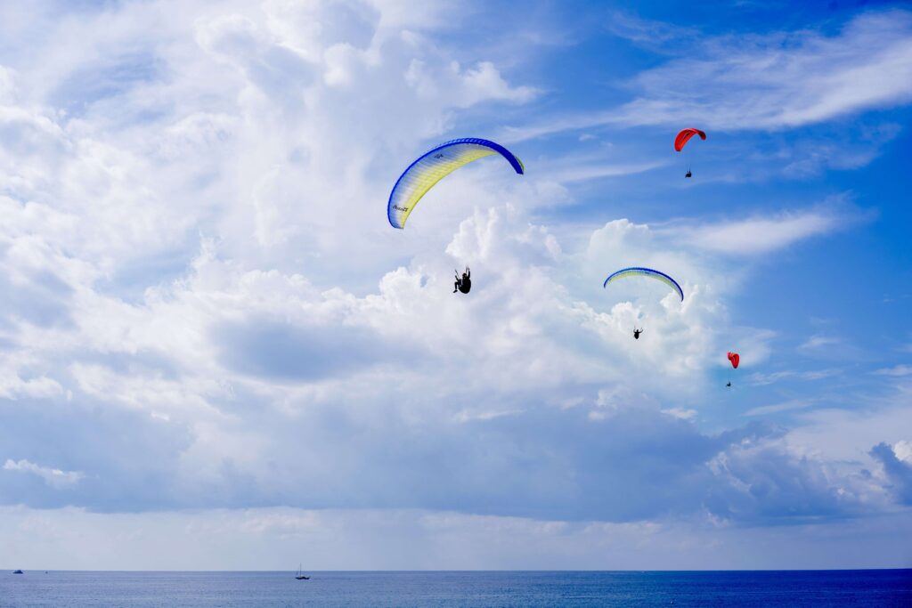 Paragliders soaring in the blue sky above the Pacific Ocean for Lima Peru highlights.