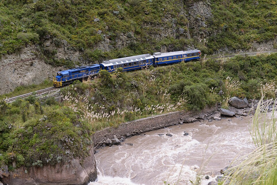 PeruRail train traveling along the Urubamba River for optimal machu picchu travel dates.