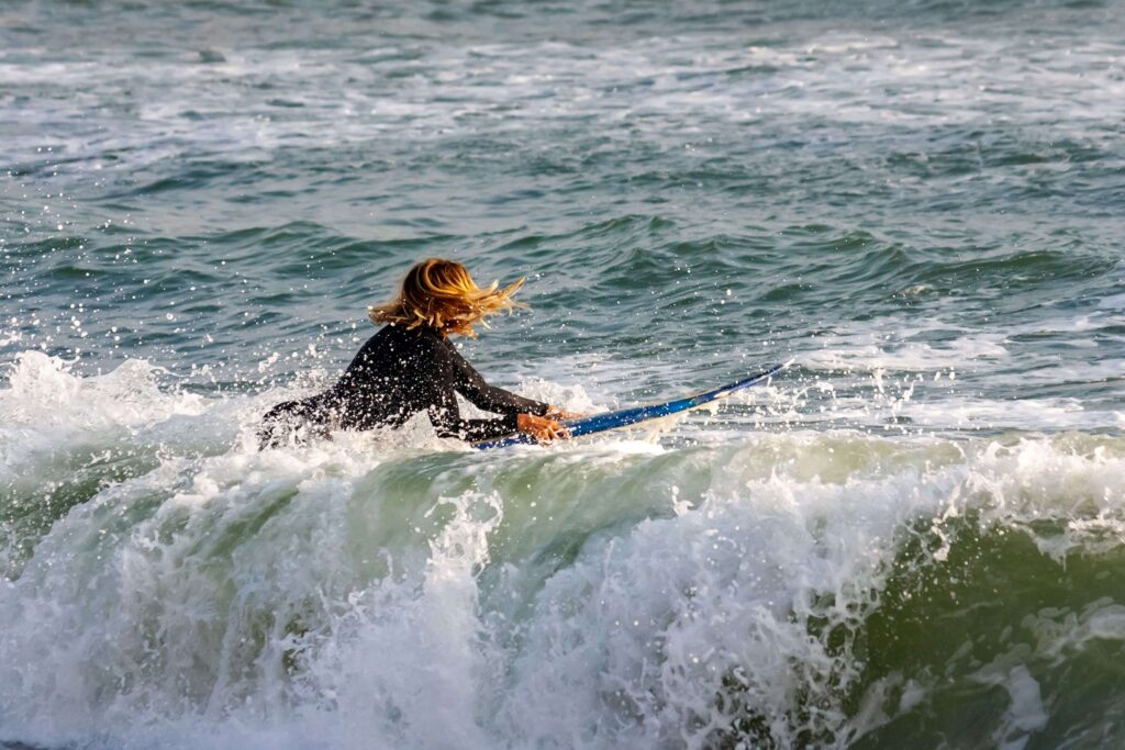 Surfers riding ocean waves at Playa Makaha beach, top what to see in Lima.