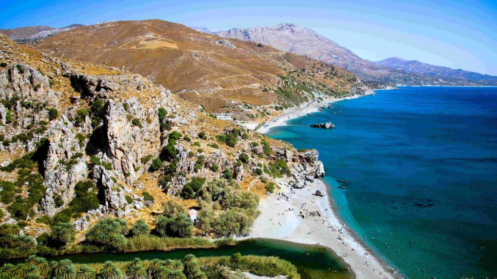 Steep cliffs and sandy shore explaining how many islands Greece has.