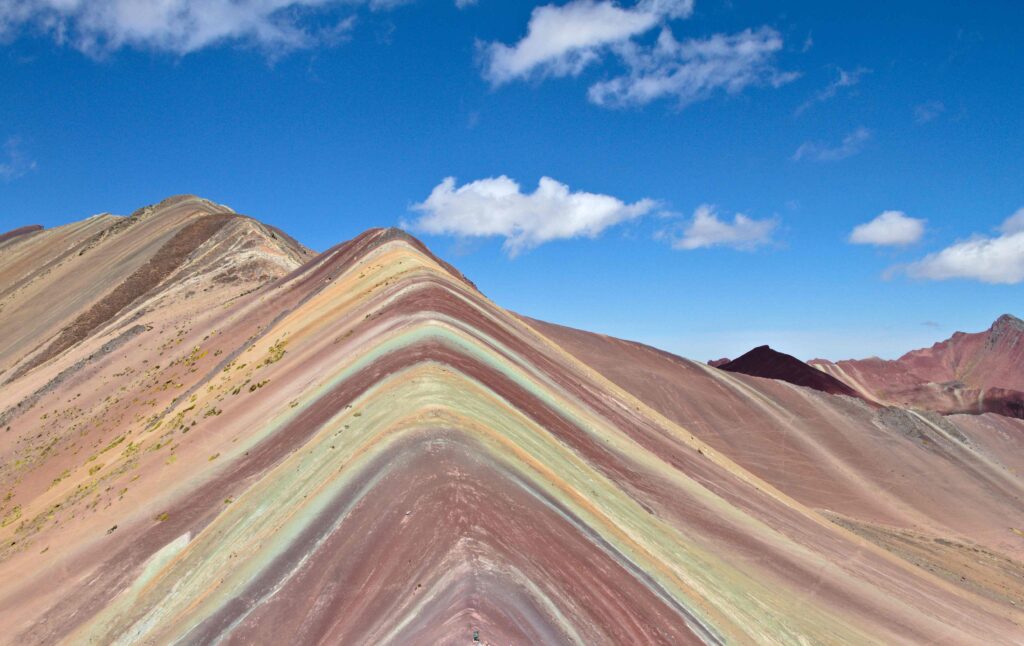 Colorful mineral stripes of Rainbow Mountain, major peru travel highlights.