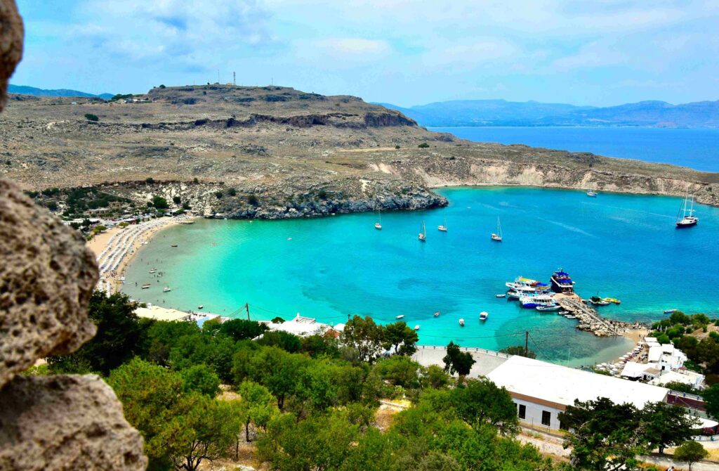 Turquoise bay near Lindos acropolis offering great Greece itinerary ideas for island hopping.