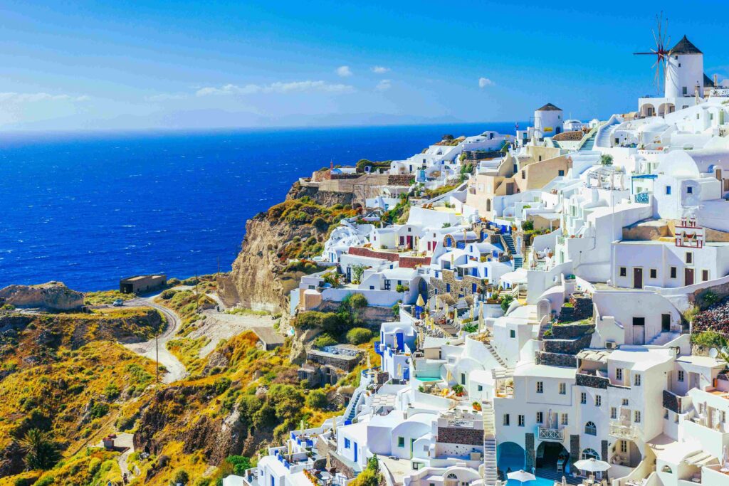 Whitewashed village on steep volcanic caldera cliffs showing how many islands in Greece.