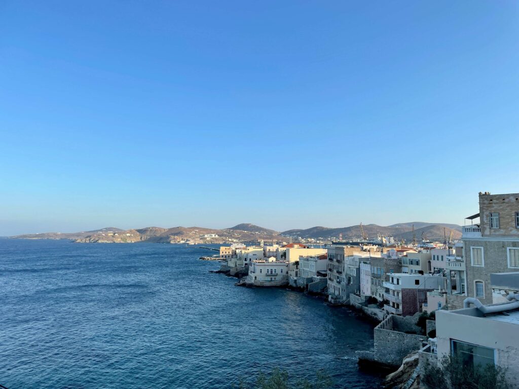 Neoclassical waterfront buildings in Syros offering must visit Greek islands charm.
