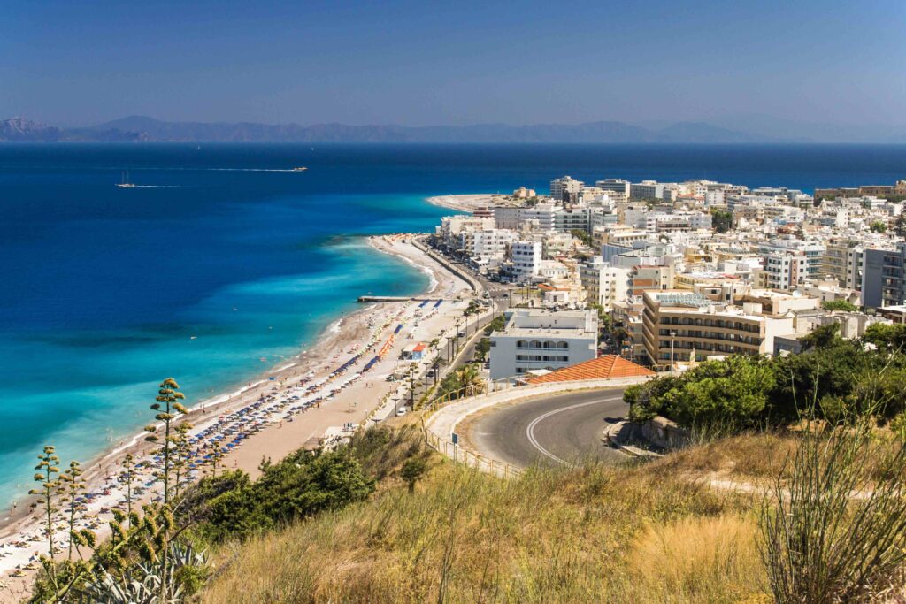 Coastal road and beachfront in Rhodes town highlighting popular islands in Greece.